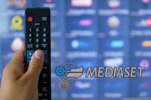 Telecomando in mano, tv e logo mediaset