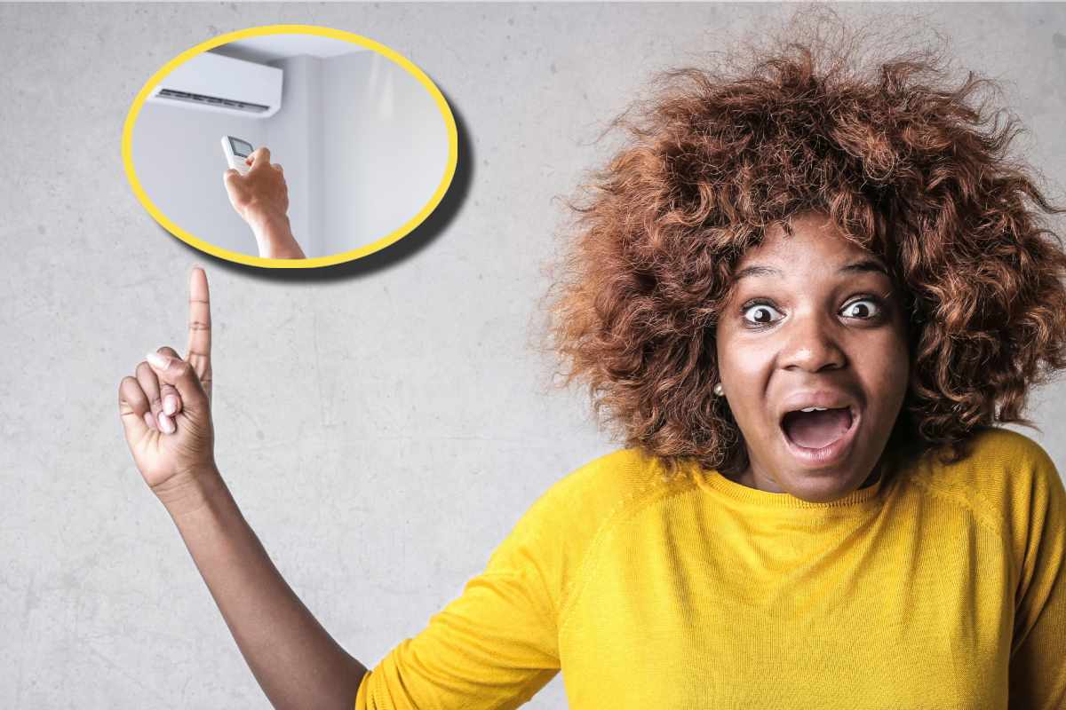 Ragazza con maglietta gialla che indica un condizionatore